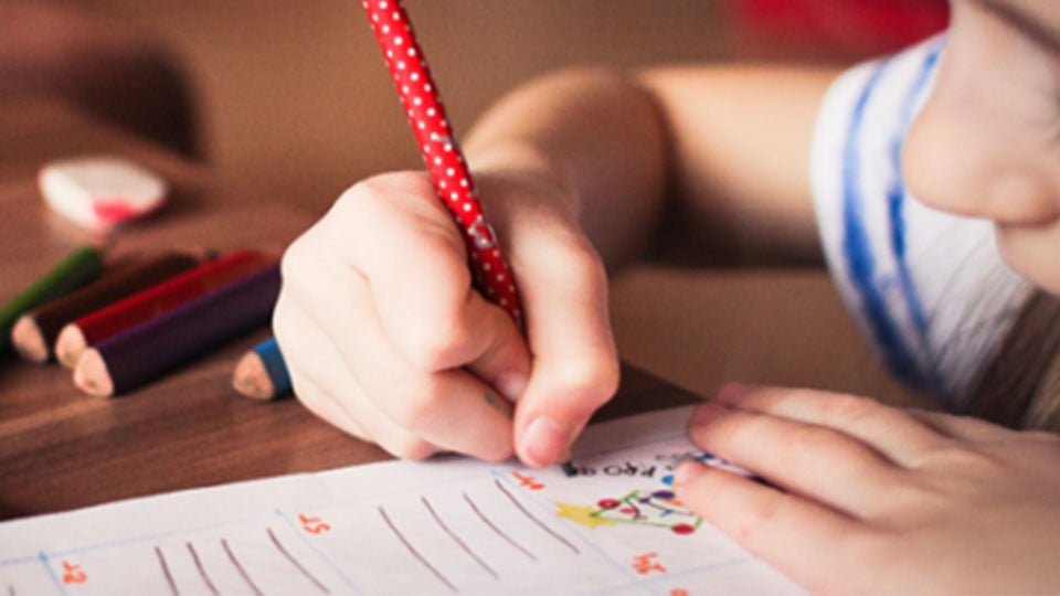 child writing in journal