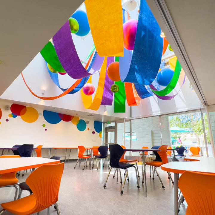 party room with color banners, tables, chairs