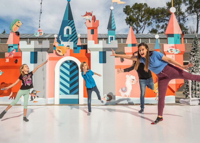 Family of four dances on a sock skating rink