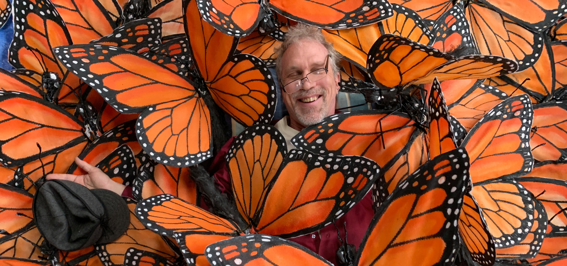 Christopher Lutter among giant monarch butterflies made from recycled and upcycled materials.