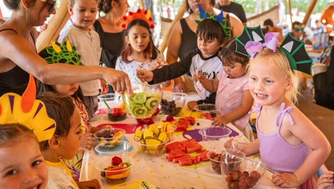 A big group of kids enjoy a dino-themed party