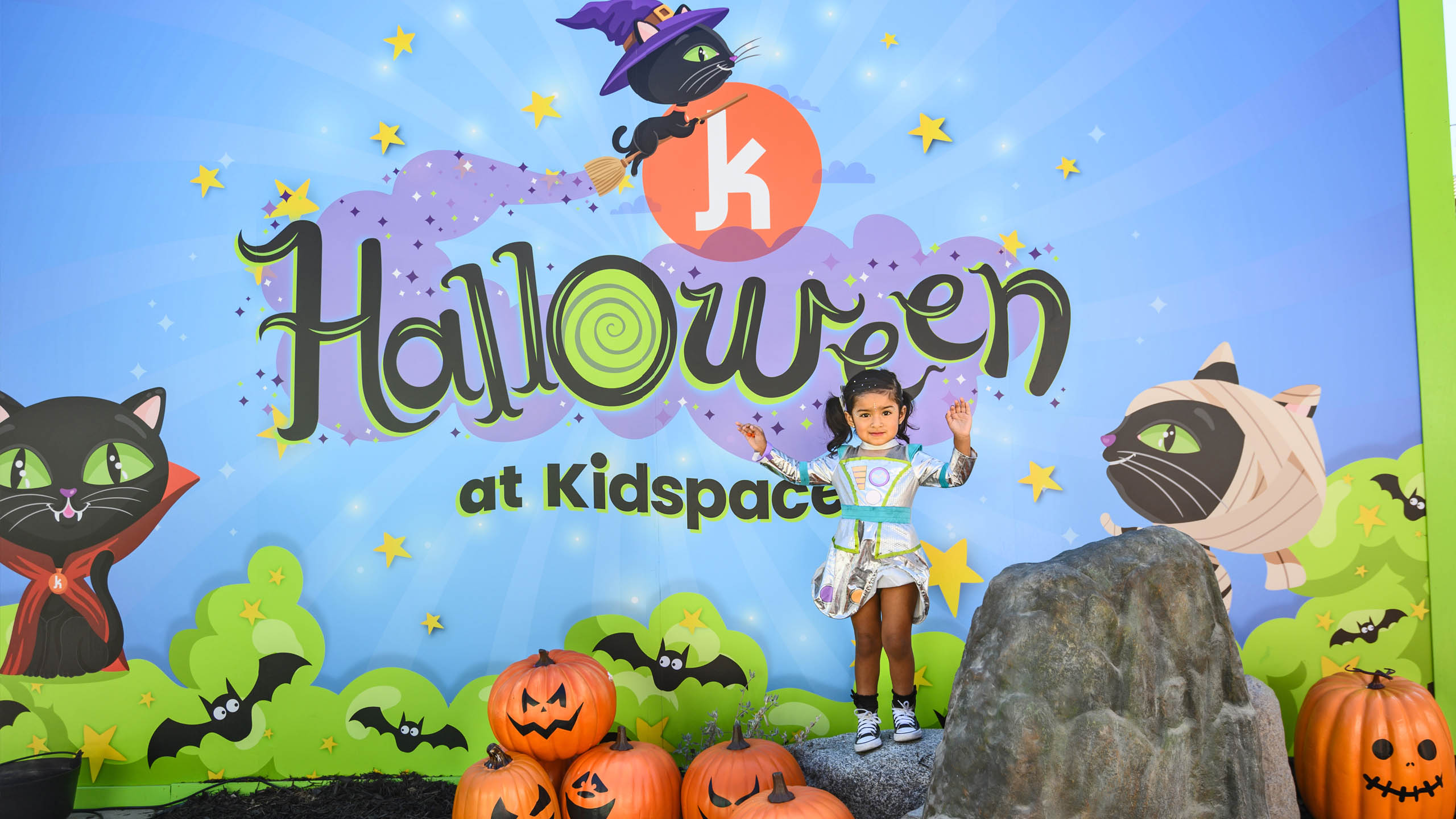 A girl in a Halloween costume poses.
