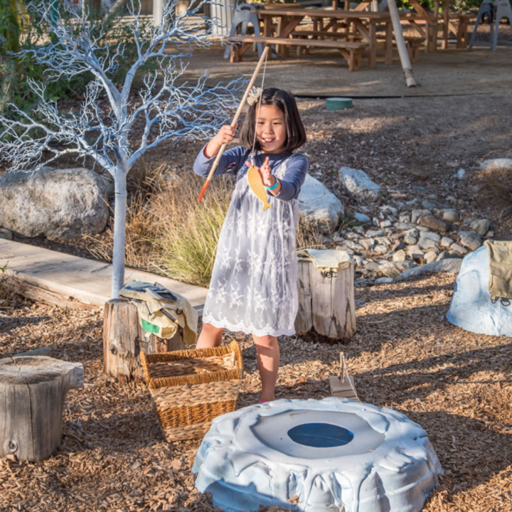 Child pretending to ice fish