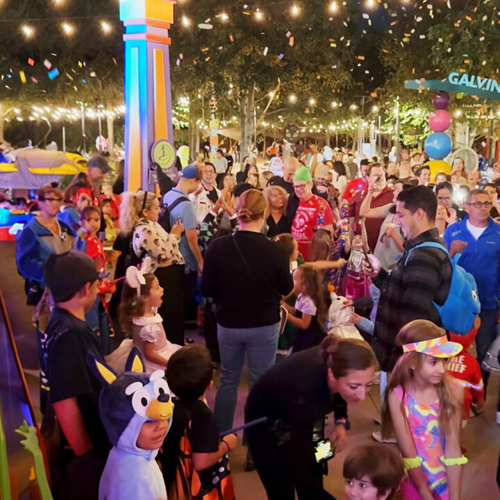 crowded nighttime outdoor event with confetti