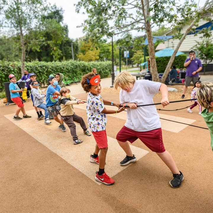 Kids play tug of war at a private party