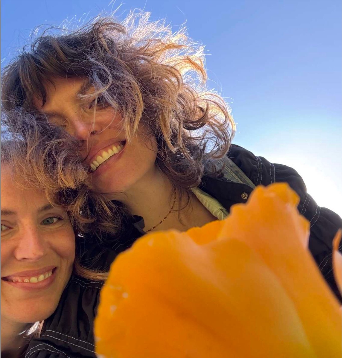 Two women and a poppy flower