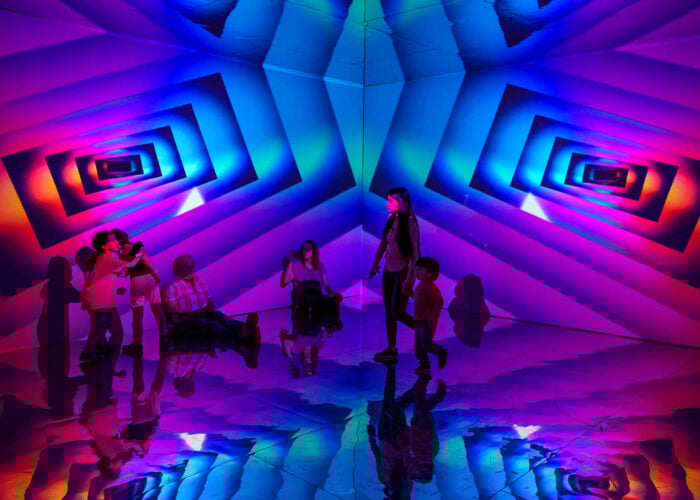 families play in a color infinity room with geometric patterns