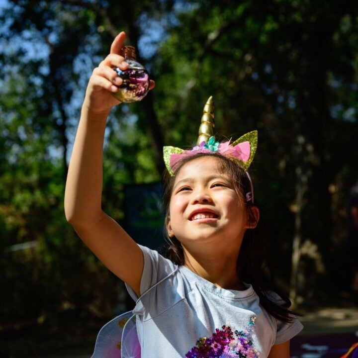 Child holds up potion bottle