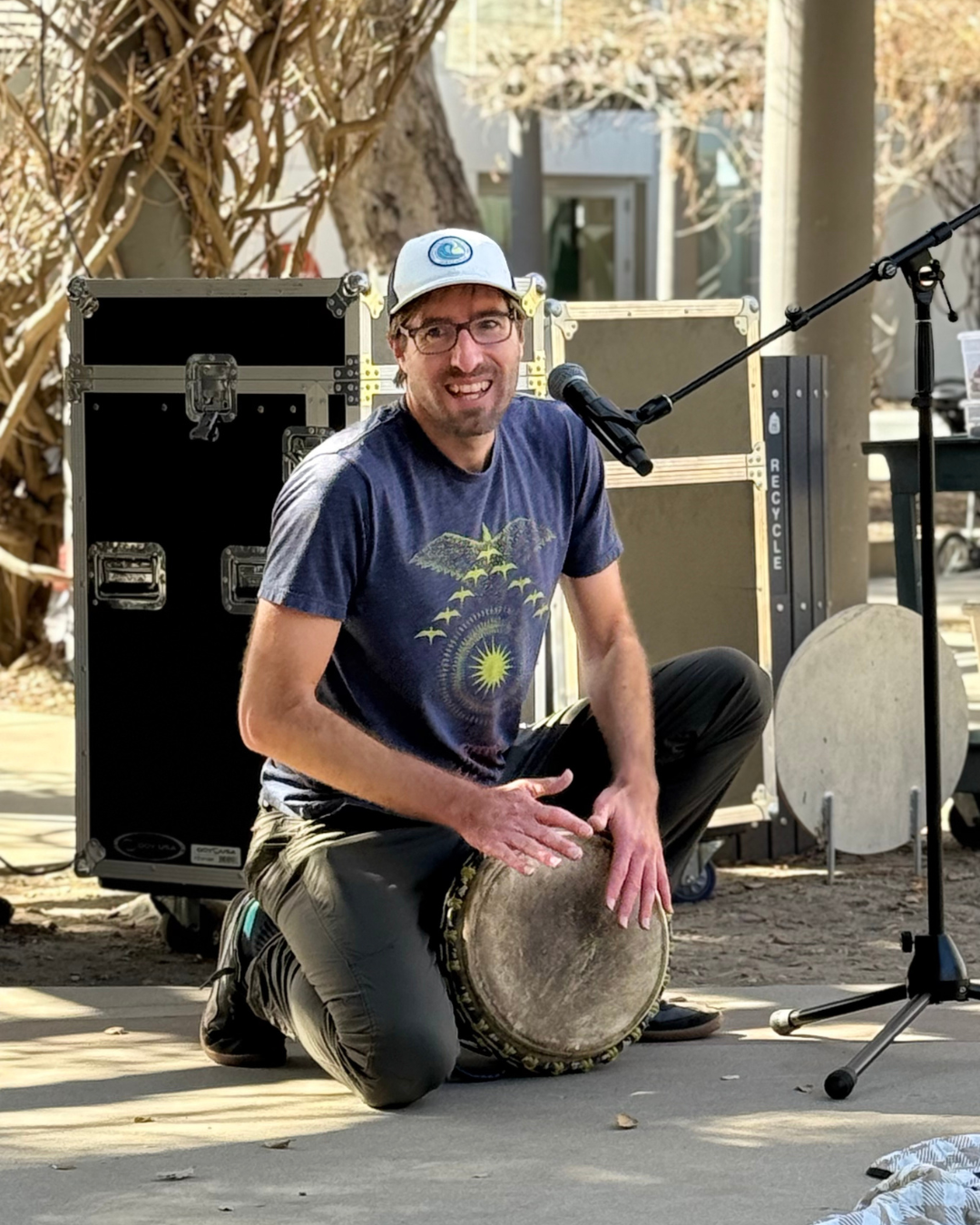 Smiling man plays the drum
