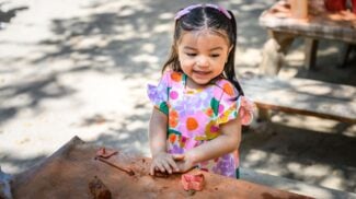 Toddler playing with clay