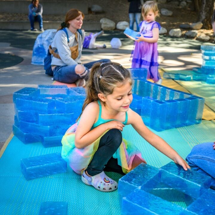 child builds with ice blocks