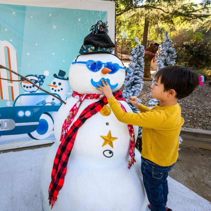 Child decorates snowman