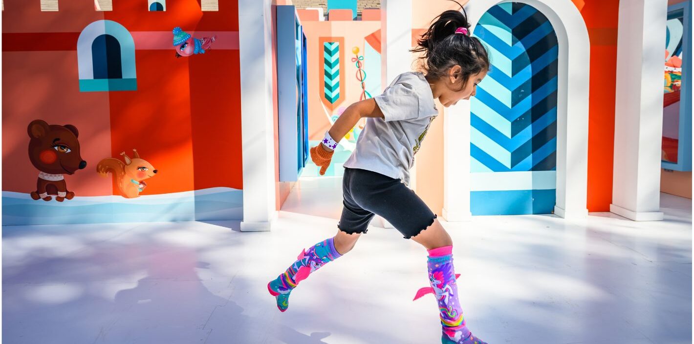 Child leaping in colorful socks