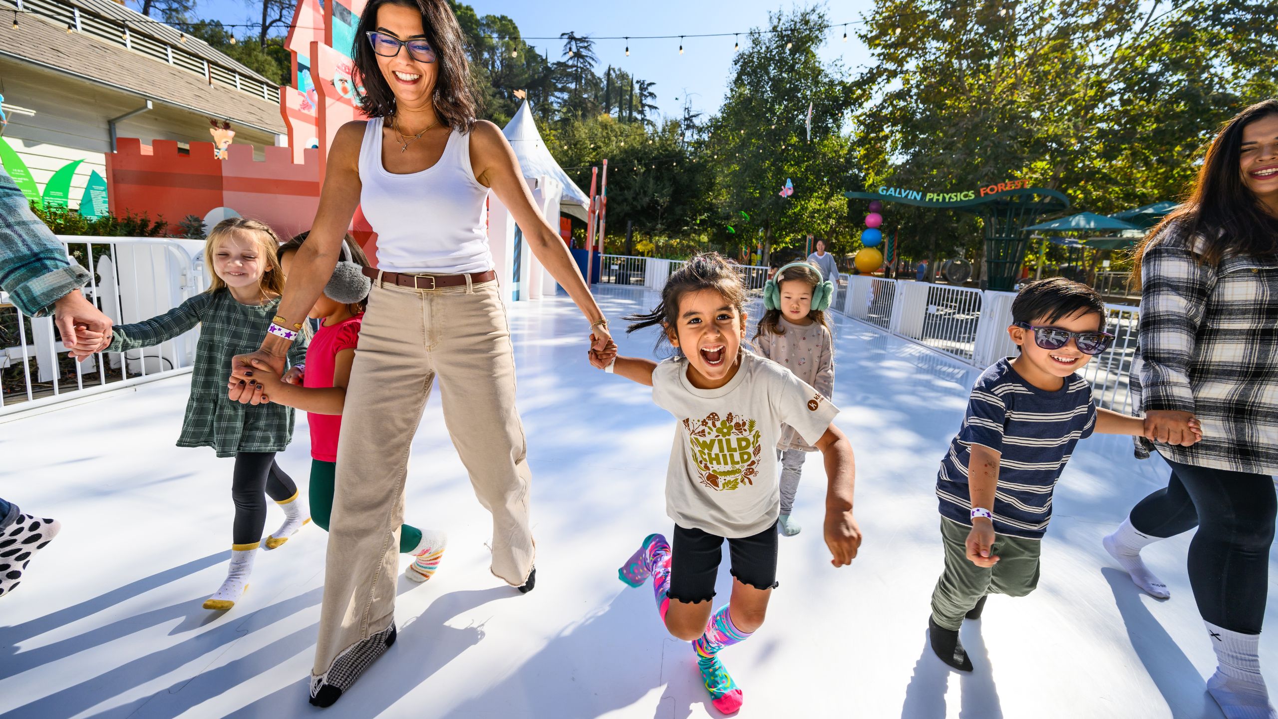 Family sliding on the sock skating rink
