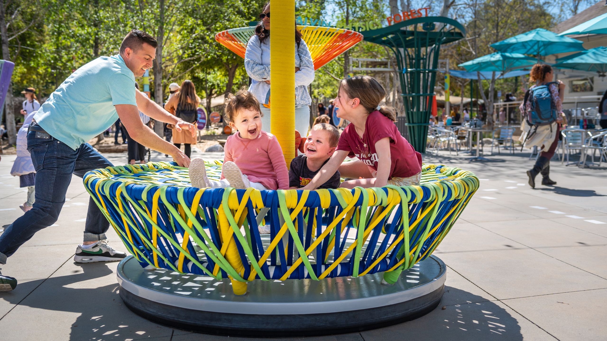 children spin on a giant top
