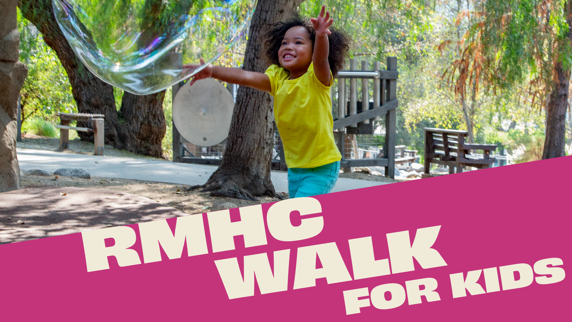 Child in yellow chases a bubble