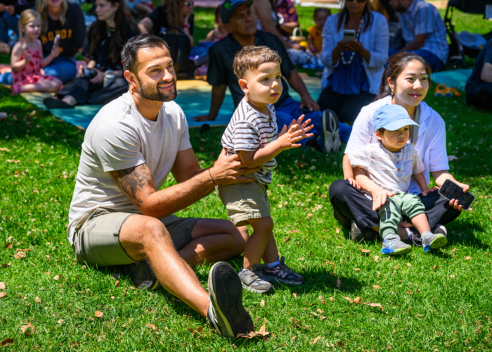 children and adults in the grass