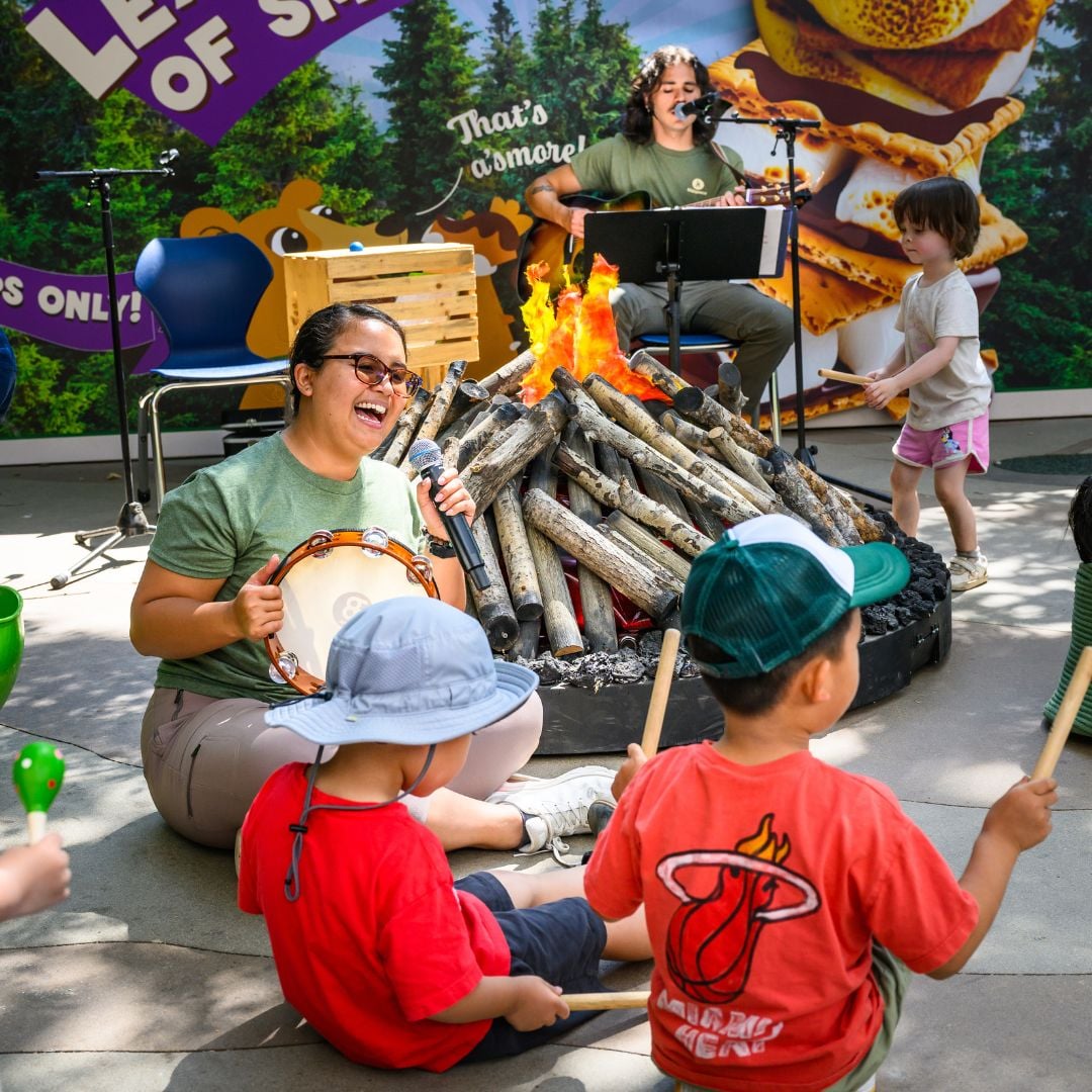 People singing around a campfire