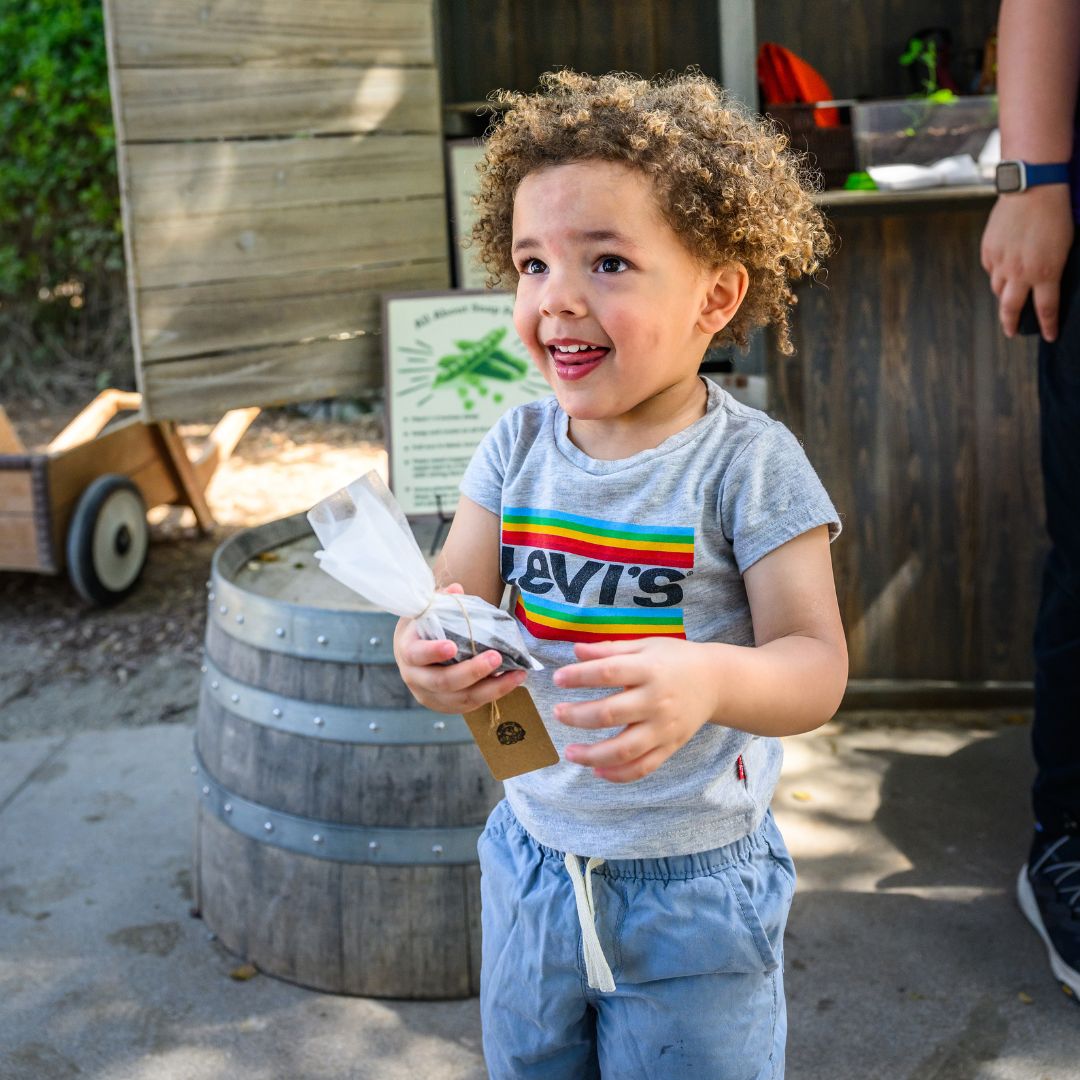 Child with a bag of seeds