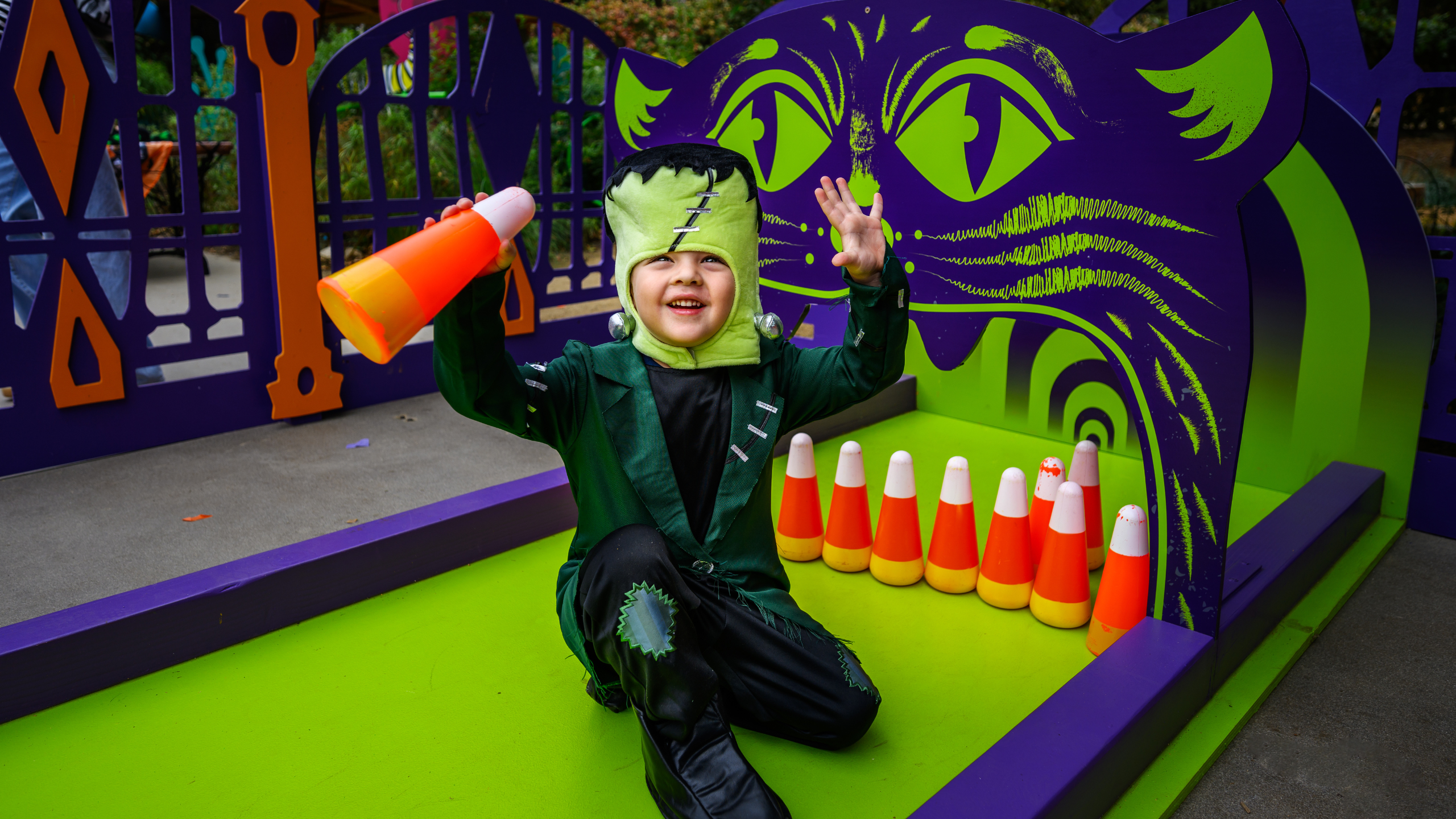 Child in costume play with bowling pins